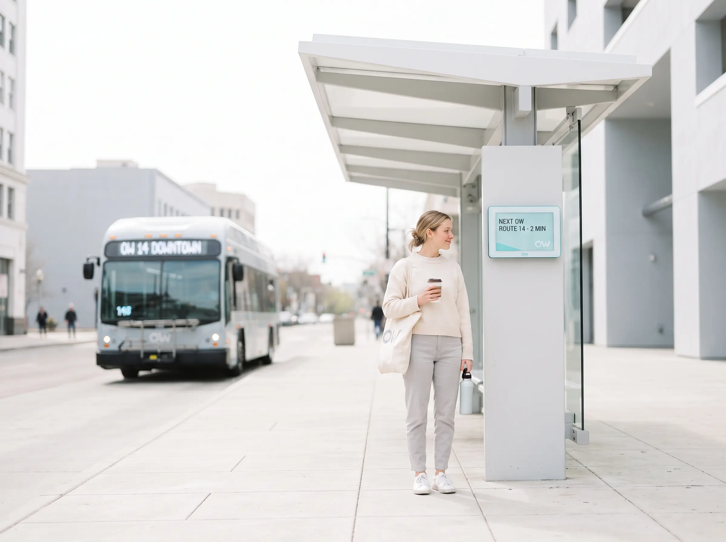 OW Optimize the World — commuter waiting at a city bus stop